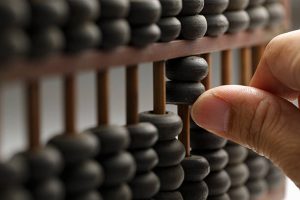 Old wooden abacus with a calculated