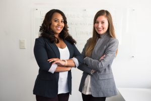 two-smiling-women-in-gray-and-black-coat-1181527